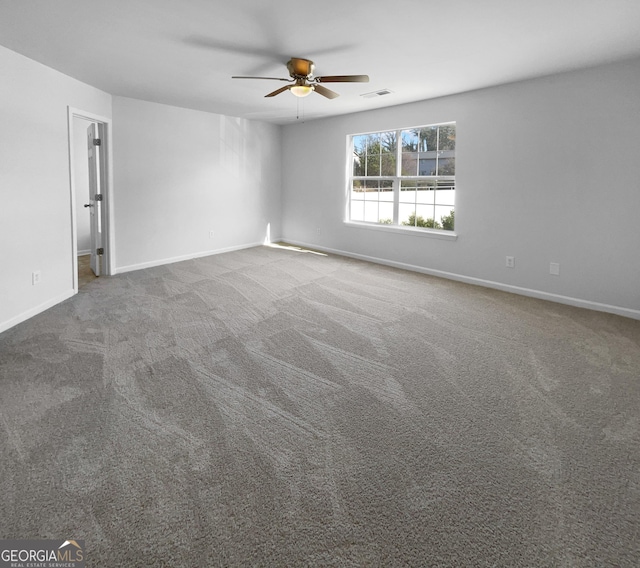 spare room featuring carpet flooring and ceiling fan