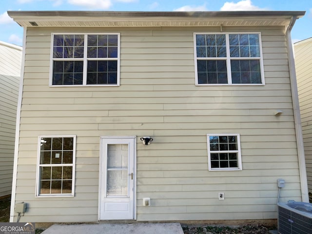 rear view of property featuring central AC unit