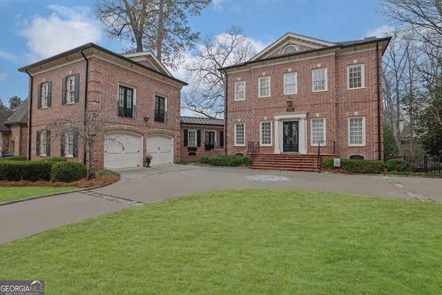 view of front of property featuring a front yard and a garage