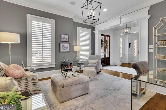 living room featuring crown molding and light hardwood / wood-style flooring