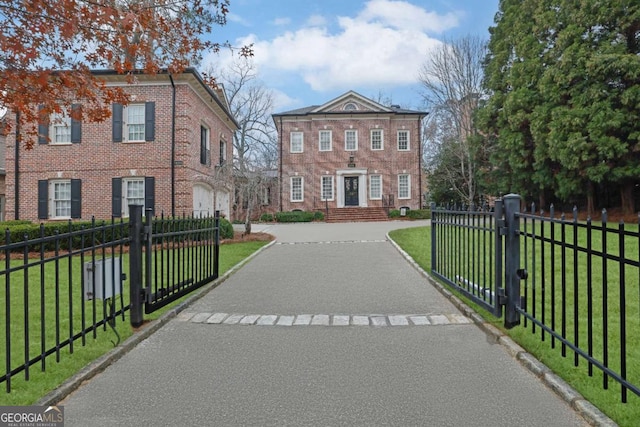 view of front of property with a front yard and a garage