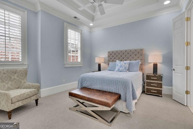 carpeted bedroom with a tray ceiling, ceiling fan, and ornamental molding