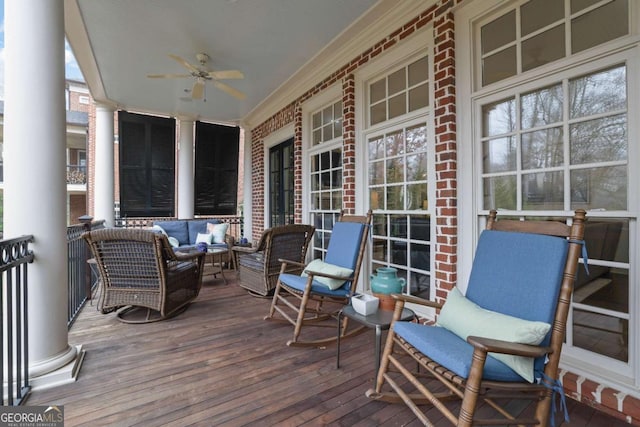 wooden deck with covered porch and ceiling fan