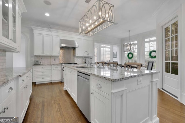 kitchen featuring sink, stainless steel appliances, an island with sink, extractor fan, and white cabinets