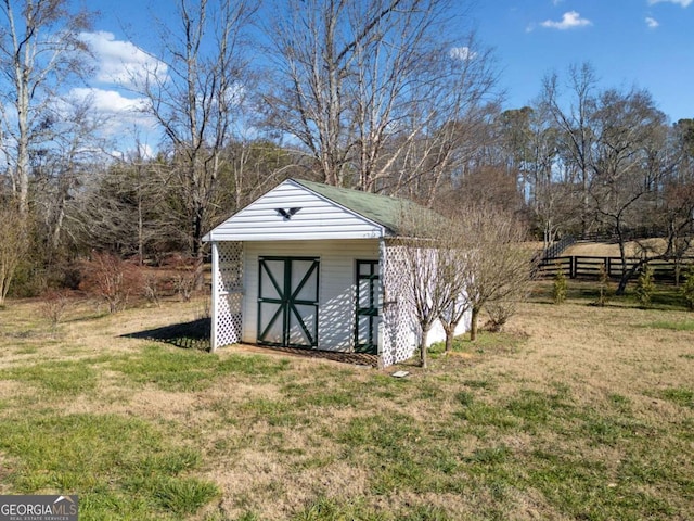 view of outbuilding with a yard