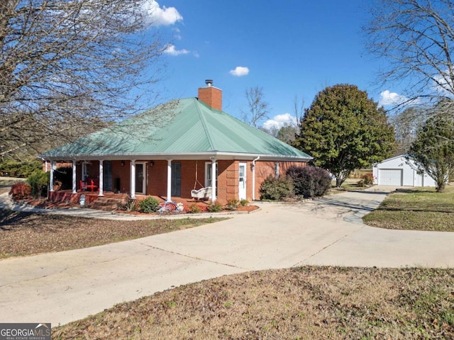 view of front of property with an outbuilding, a garage, and covered porch