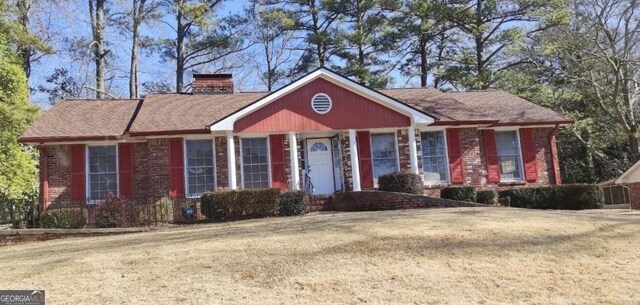 ranch-style home with a front lawn