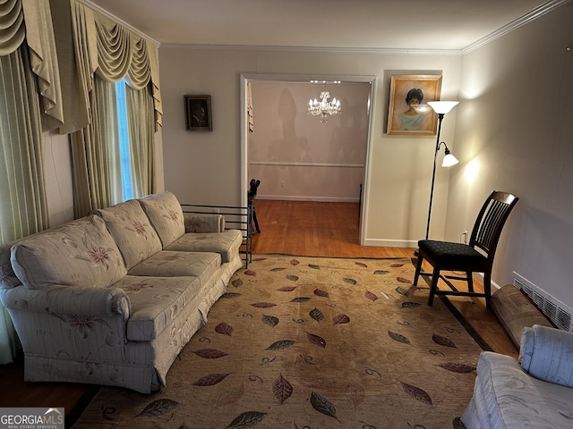 living room featuring ornamental molding, hardwood / wood-style floors, and a notable chandelier