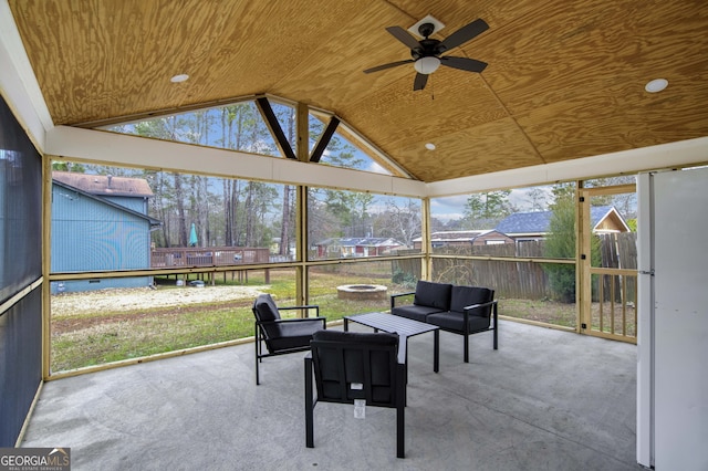 sunroom / solarium with ceiling fan, wood ceiling, and lofted ceiling