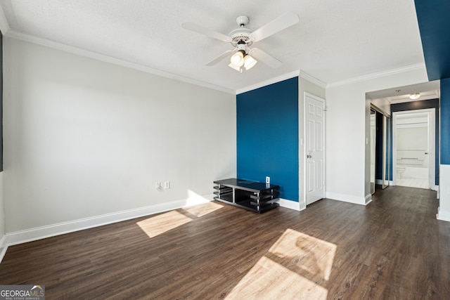 interior space featuring ceiling fan, dark hardwood / wood-style flooring, ornamental molding, and a textured ceiling