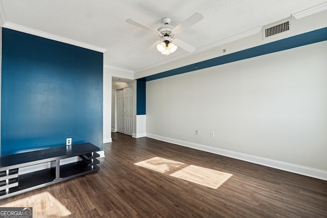 interior space with a textured ceiling, ceiling fan, ornamental molding, and dark wood-type flooring