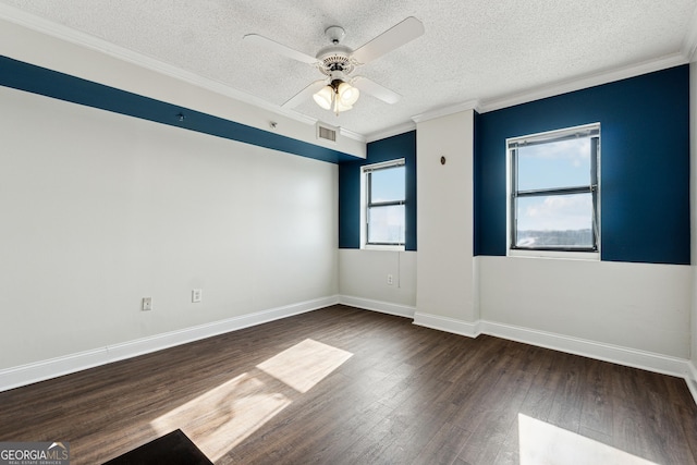 spare room with a wealth of natural light, dark hardwood / wood-style floors, ceiling fan, and ornamental molding