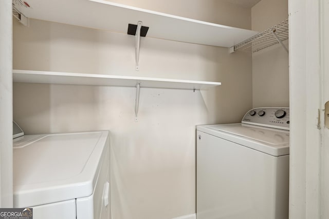 laundry room with washing machine and clothes dryer