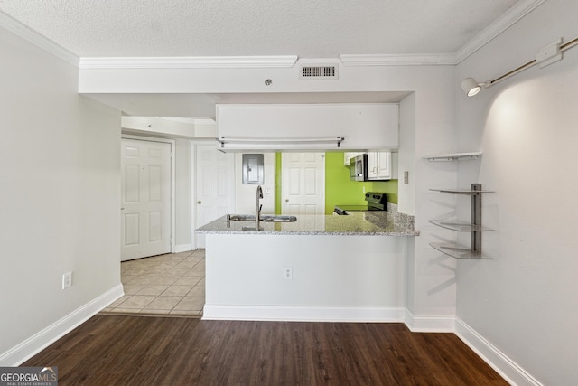 kitchen featuring kitchen peninsula, light stone countertops, sink, and appliances with stainless steel finishes