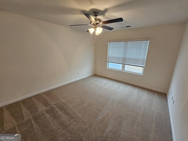 spare room with ceiling fan and carpet floors