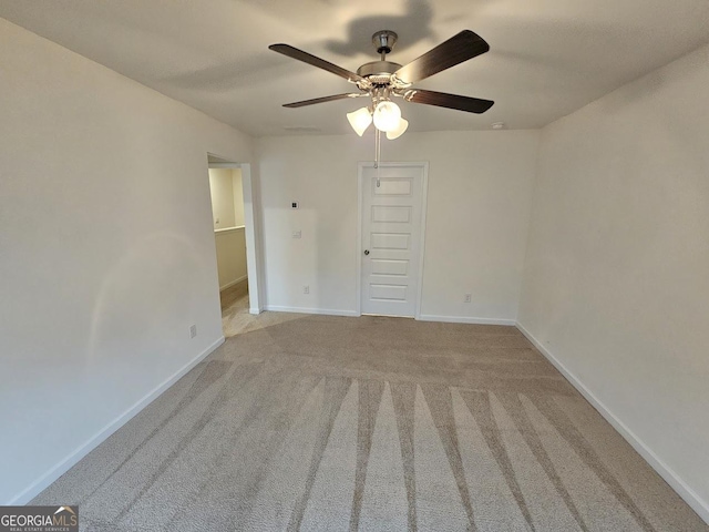 carpeted empty room featuring ceiling fan