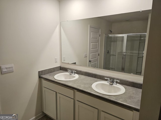 bathroom with vanity and a shower with door