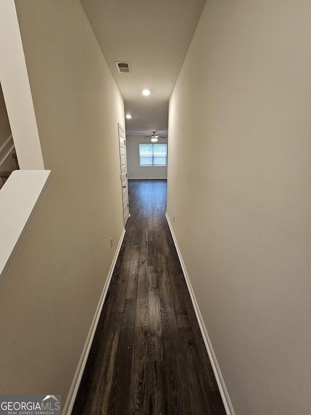 hallway with dark hardwood / wood-style flooring