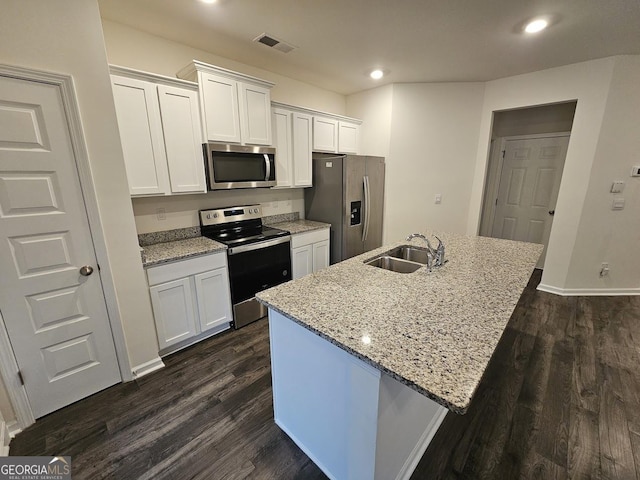 kitchen featuring white cabinetry, a kitchen island with sink, sink, and appliances with stainless steel finishes