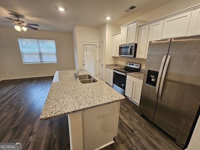 kitchen featuring a kitchen island with sink, sink, white cabinets, and stainless steel appliances