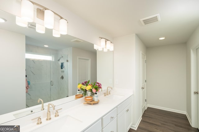 bathroom featuring vanity, hardwood / wood-style flooring, and a shower with door