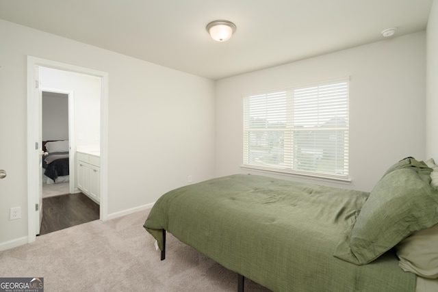 carpeted bedroom featuring ensuite bathroom