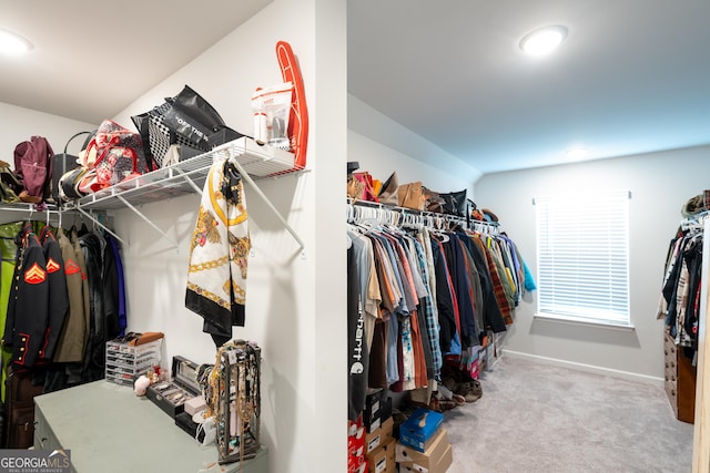 spacious closet with carpet floors and vaulted ceiling