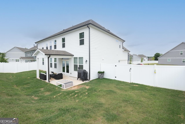 rear view of property featuring central AC unit, a yard, and a patio