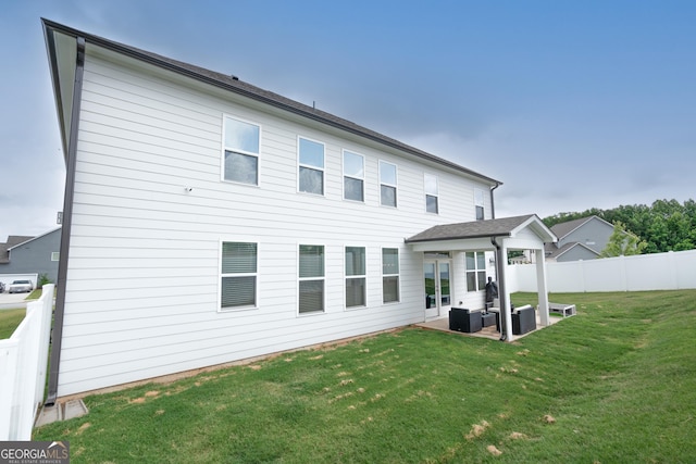 rear view of house featuring outdoor lounge area, a patio area, and a yard