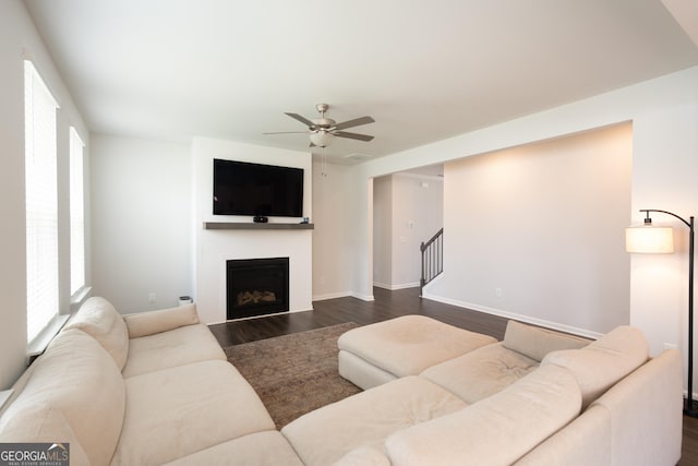 living room featuring dark hardwood / wood-style floors and ceiling fan