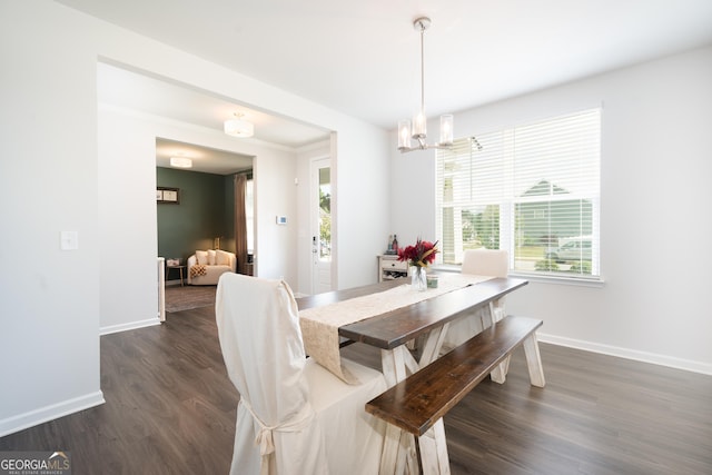 dining area with dark hardwood / wood-style flooring and a chandelier