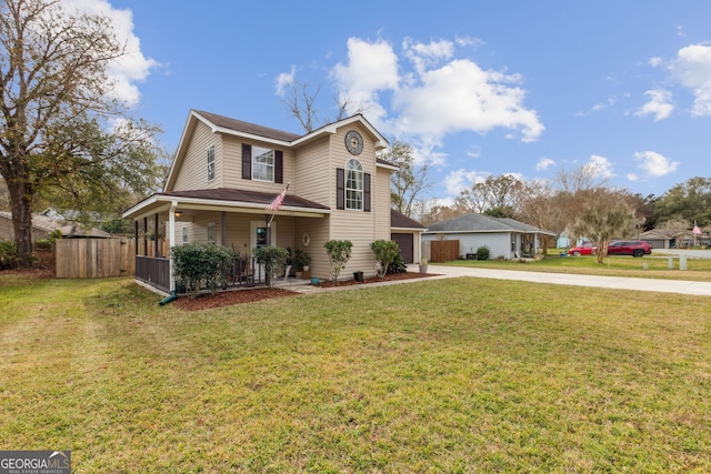 front of property featuring a garage, covered porch, and a front yard