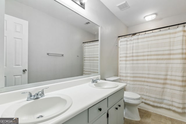 bathroom with vanity, a shower with shower curtain, and toilet