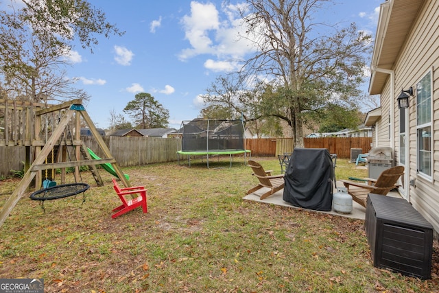 view of yard featuring a playground, a patio area, and a trampoline