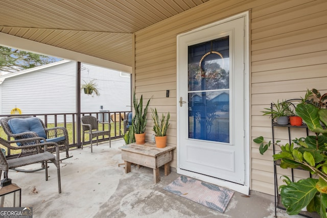 view of exterior entry featuring covered porch