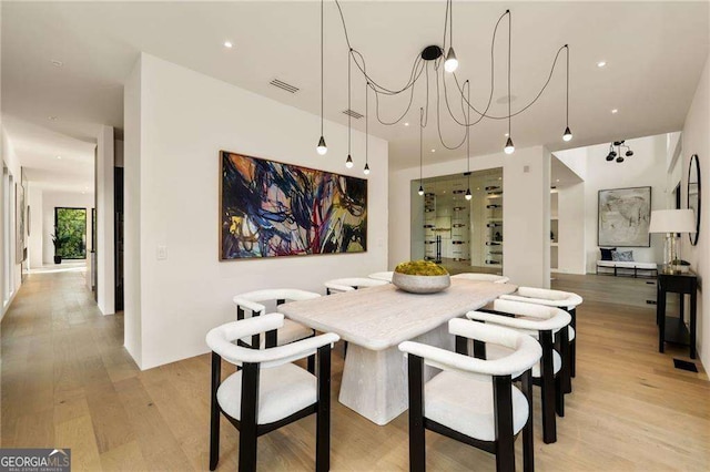 dining room featuring a notable chandelier and light wood-type flooring