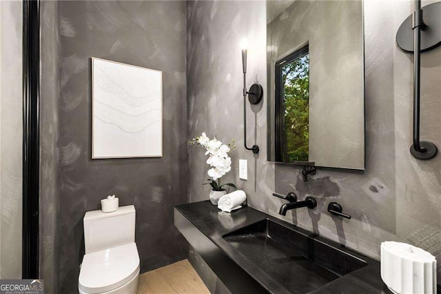 bathroom featuring sink and toilet