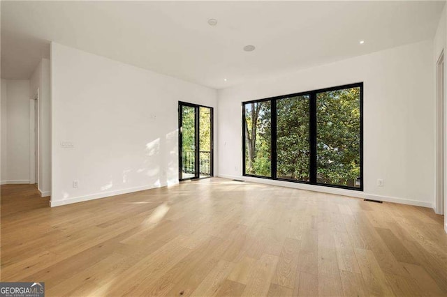 unfurnished room with light hardwood / wood-style floors