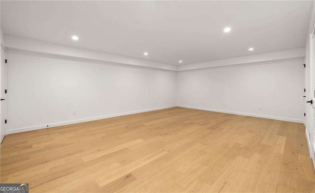 unfurnished room with light wood-type flooring