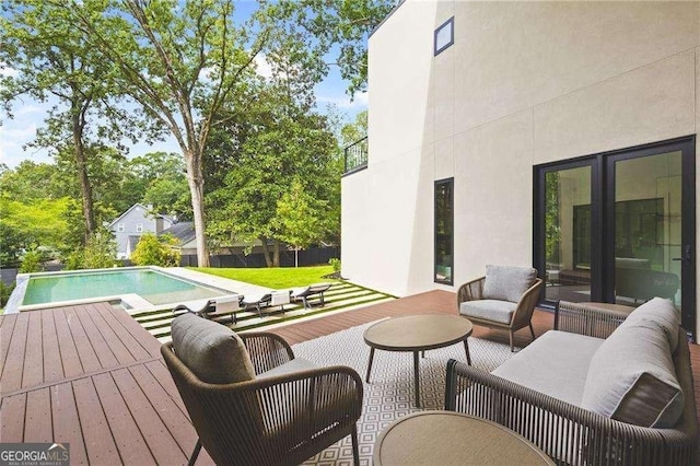 view of swimming pool featuring outdoor lounge area and a deck