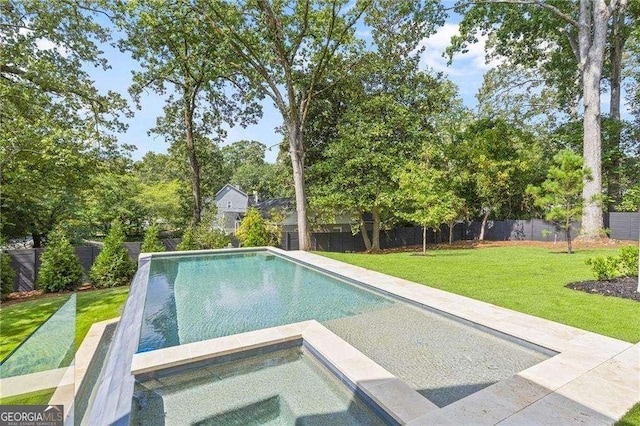 view of swimming pool with a lawn and an in ground hot tub