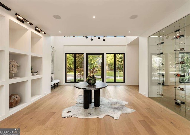 interior space featuring built in features and light hardwood / wood-style flooring