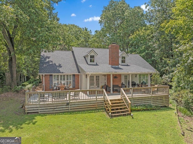 back of house with a deck, a yard, and french doors