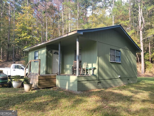 view of side of home with a lawn