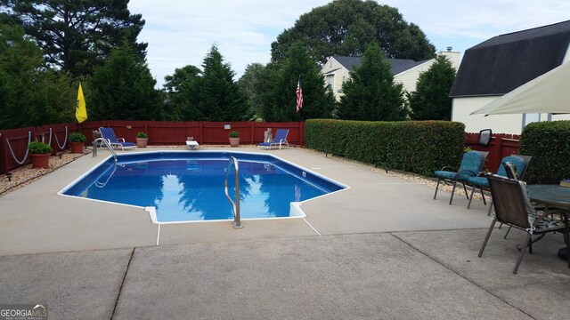 view of swimming pool featuring a patio area