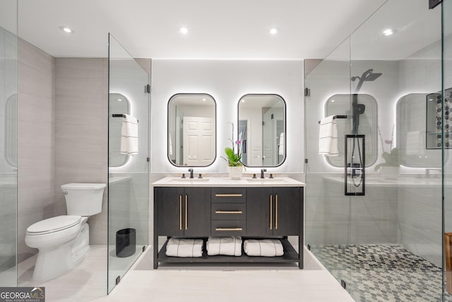 bathroom featuring vanity, tile patterned floors, toilet, tile walls, and an enclosed shower