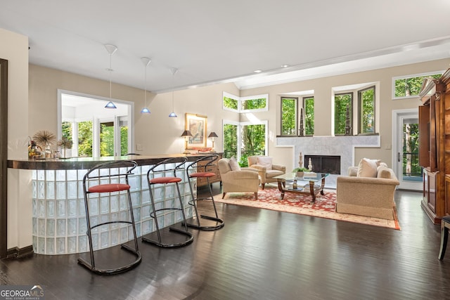 living room featuring dark hardwood / wood-style floors, plenty of natural light, and crown molding