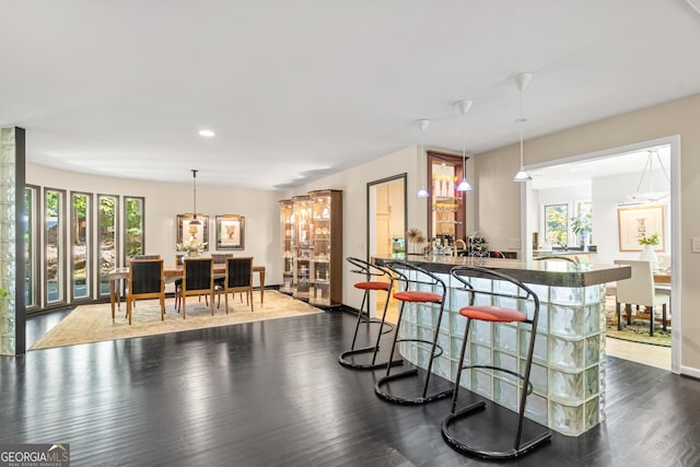 kitchen with dark hardwood / wood-style flooring and decorative light fixtures