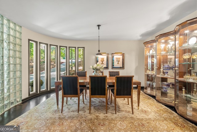 dining space with wood-type flooring