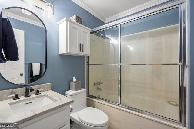 full bathroom featuring crown molding, toilet, vanity, and combined bath / shower with glass door